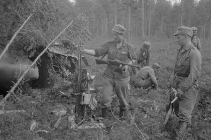 Loimola kaakko_03 Poikamme tutkivat alasammutun viholliskoneen raskasta konekivääriä_SA-kuva 22-7-1944